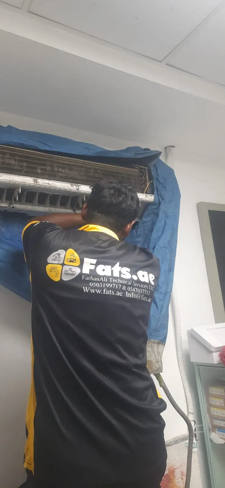 worker fixing ac